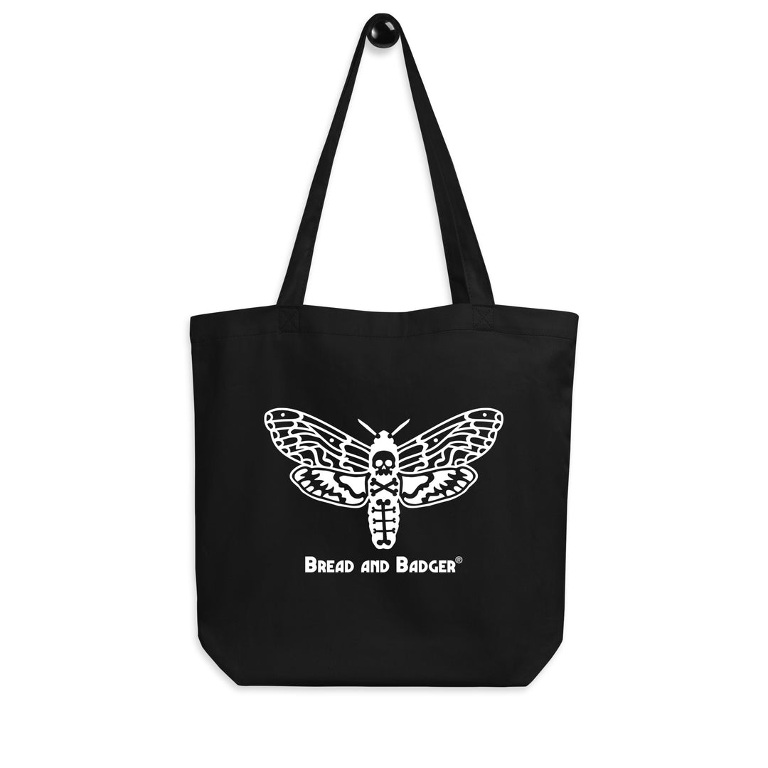 Black tote bag with a white deaths head moth design and 'Bread and Badger' text on a white background