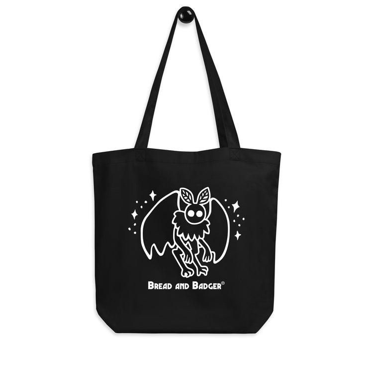Black tote bag with a white mothman  graphic and 'Bread and Badger' text on a white background