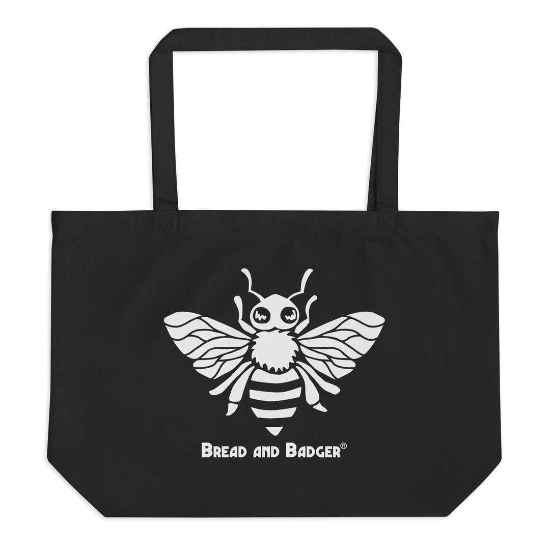Black tote bag with a white bee design and 'Bread and Badger' text on a white background