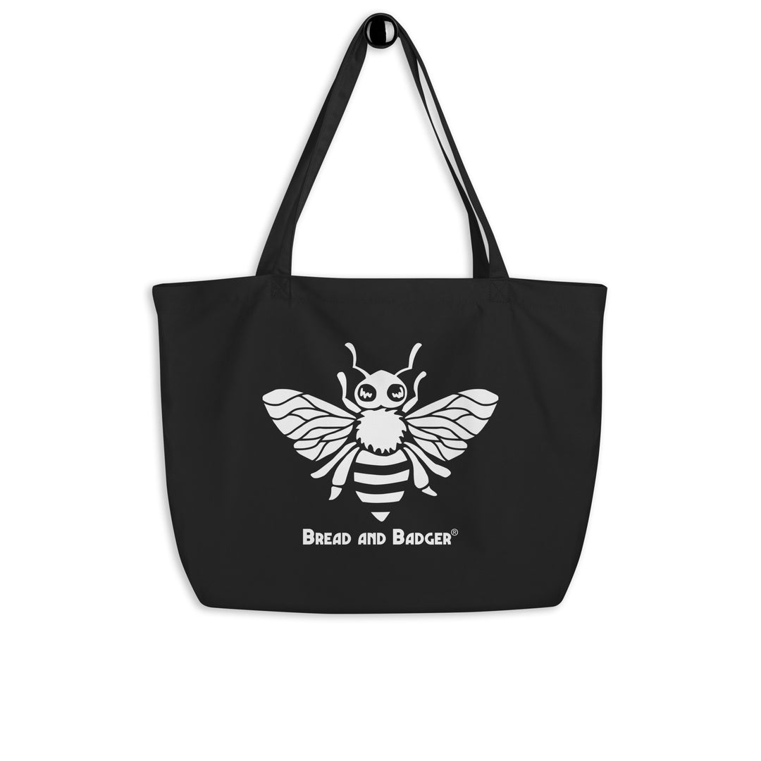 Black tote bag with a white bee design and 'Bread and Badger' text on a white background