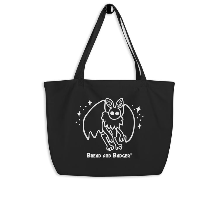 Black tote bag with a white mothman  graphic and 'Bread and Badger' text on a white background