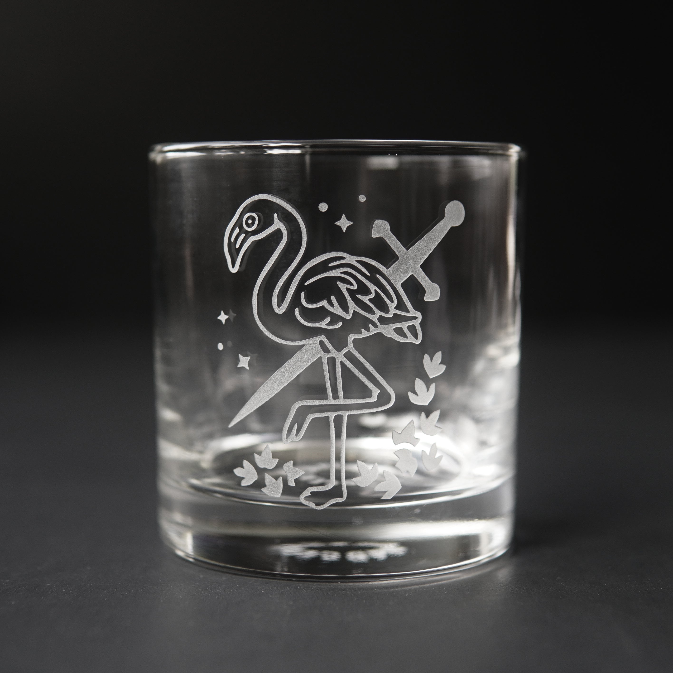 lowball glass etched with a flamingo and sword