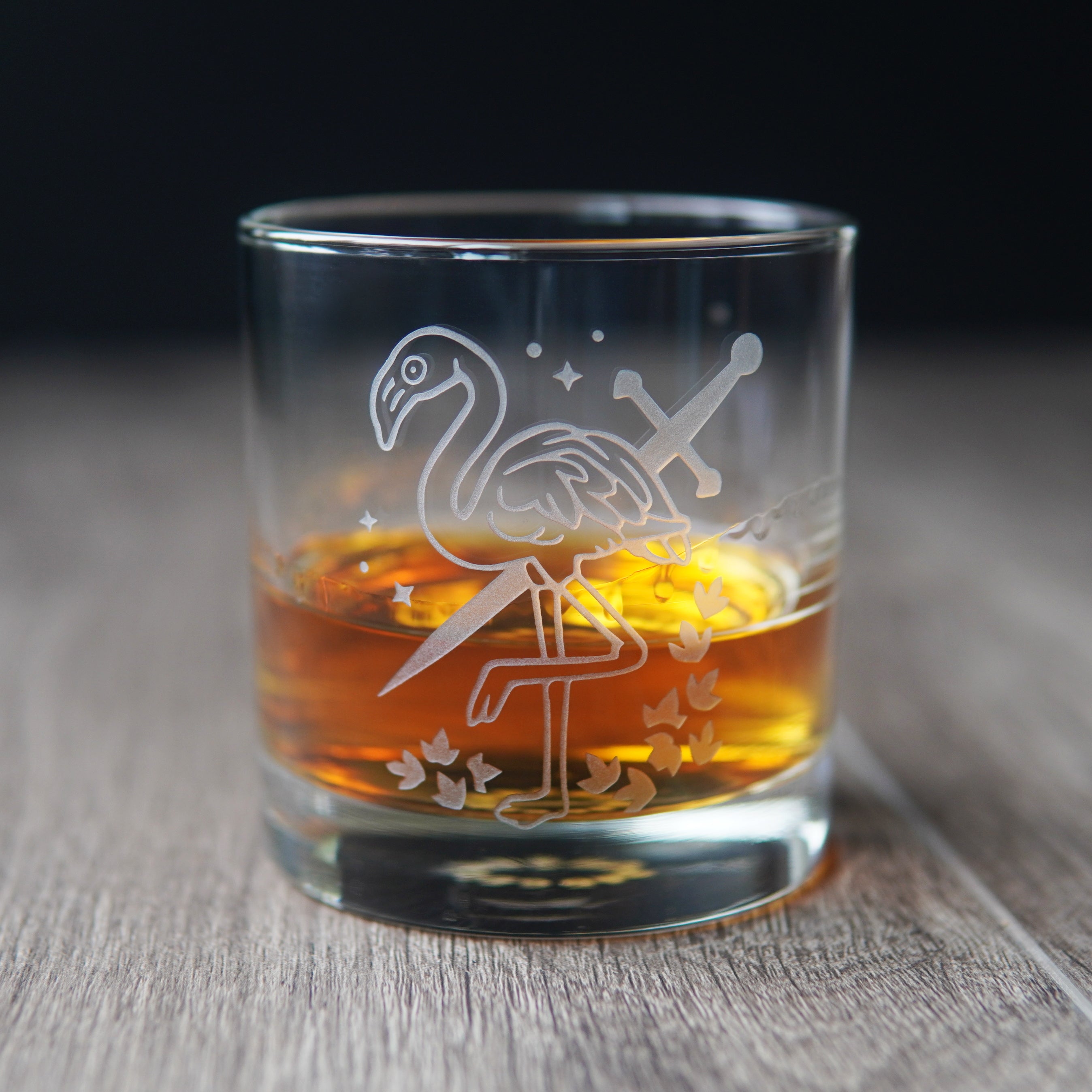flamingo and sword etched lowball glass with whiskey