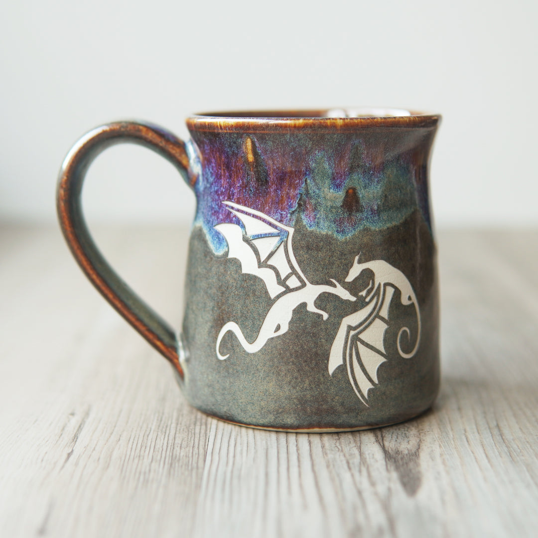 winged dragons engraved on a mug