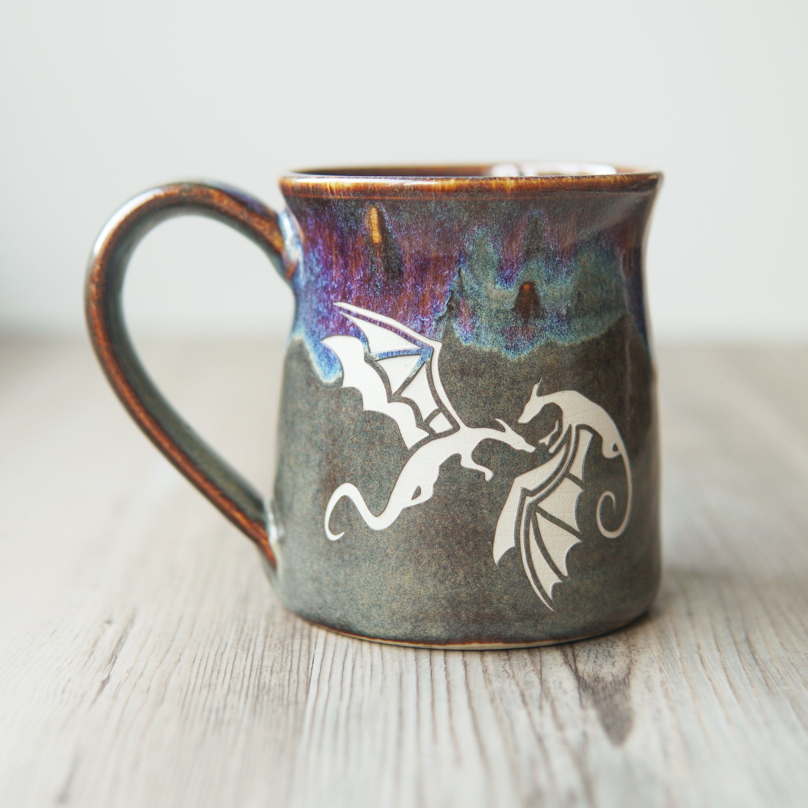 winged dragons engraved on a mug