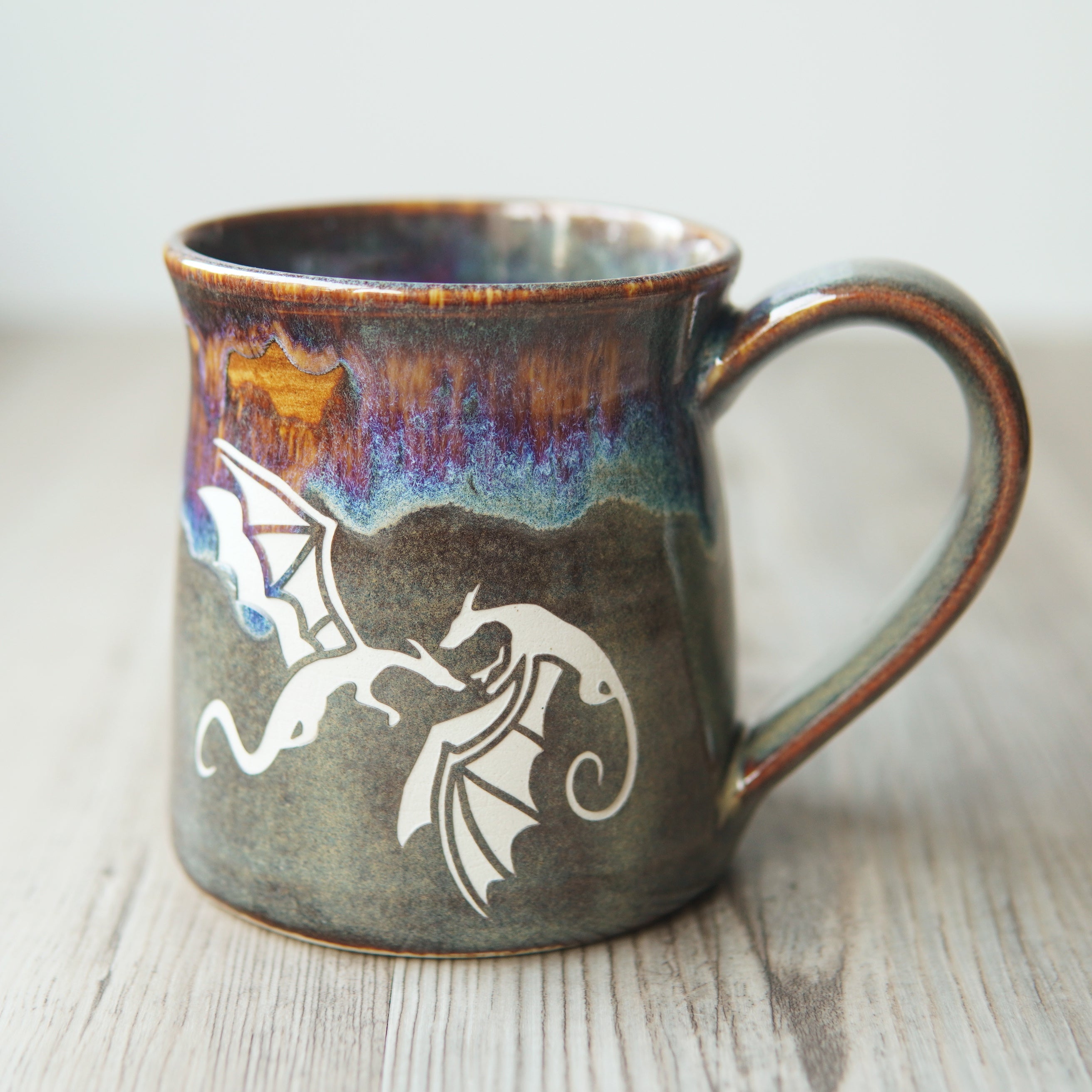 winged dragons engraved on a mug