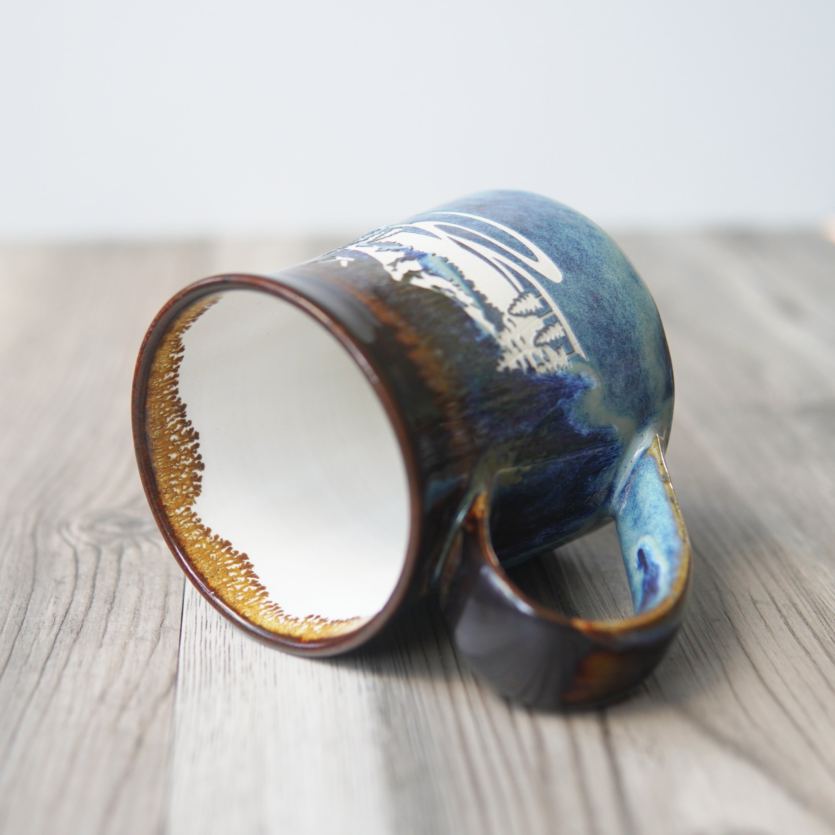 Mountain mug in coastline glaze, showing the white inside