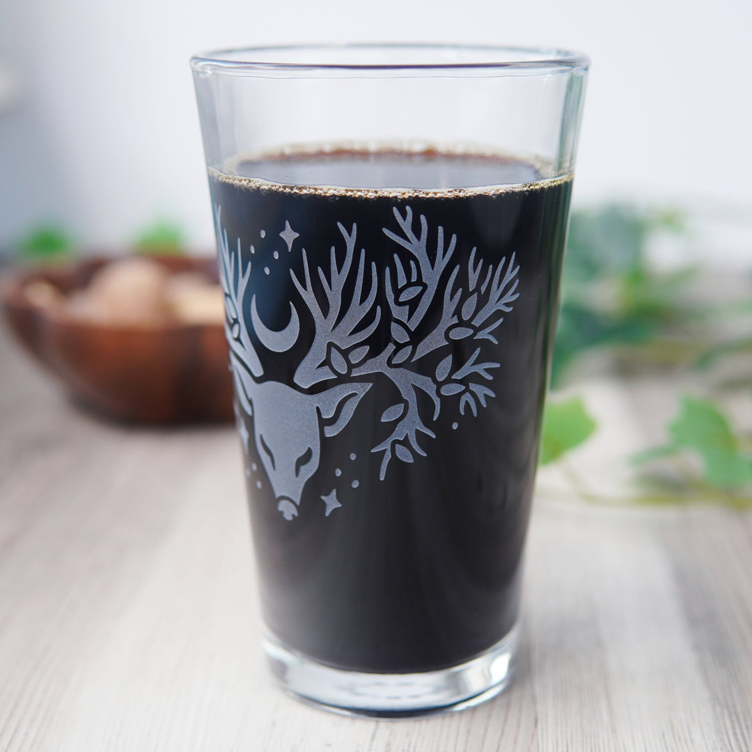etched pint glass with a deer head whose antlers are tree branches