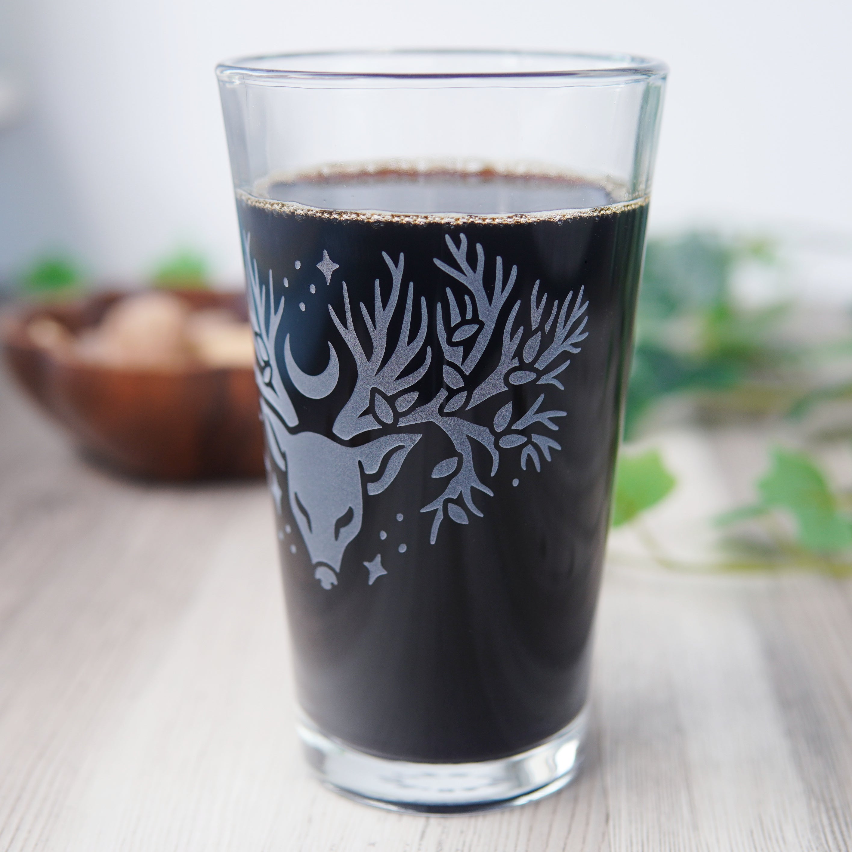 etched pint glass with a deer head whose antlers are tree branches
