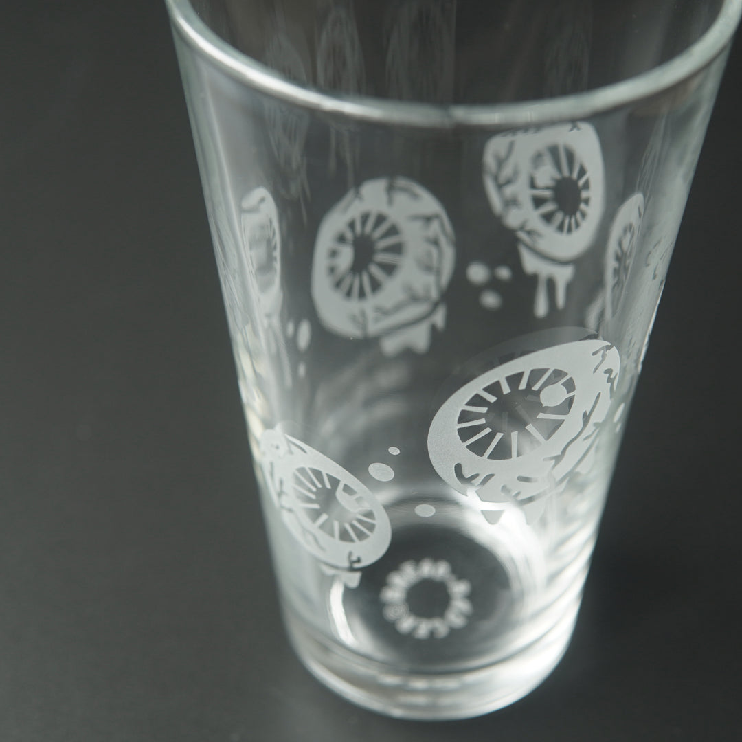 Pint glass engraved with dripping, veiny eyeballs and bubbles