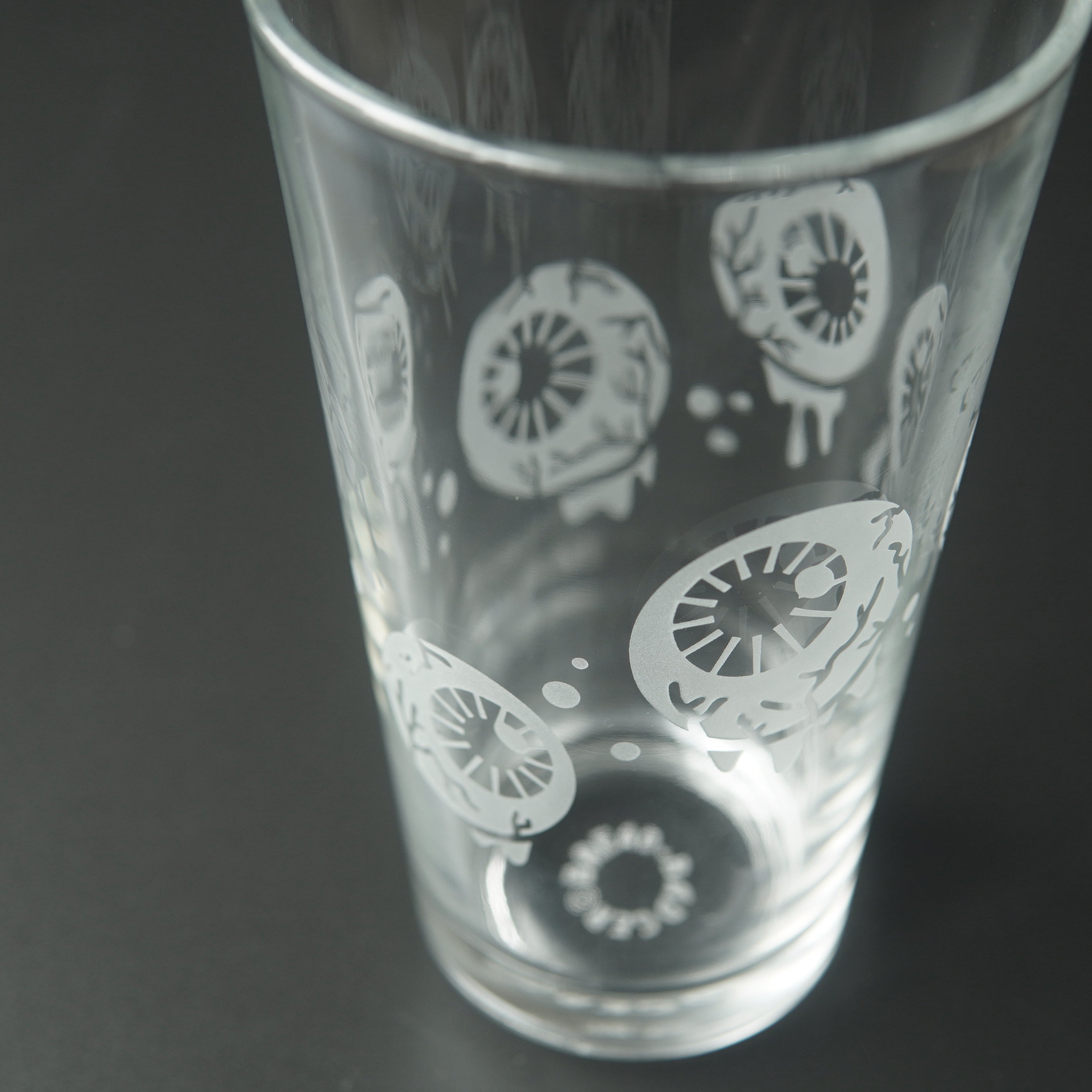Pint glass engraved with dripping, veiny eyeballs and bubbles