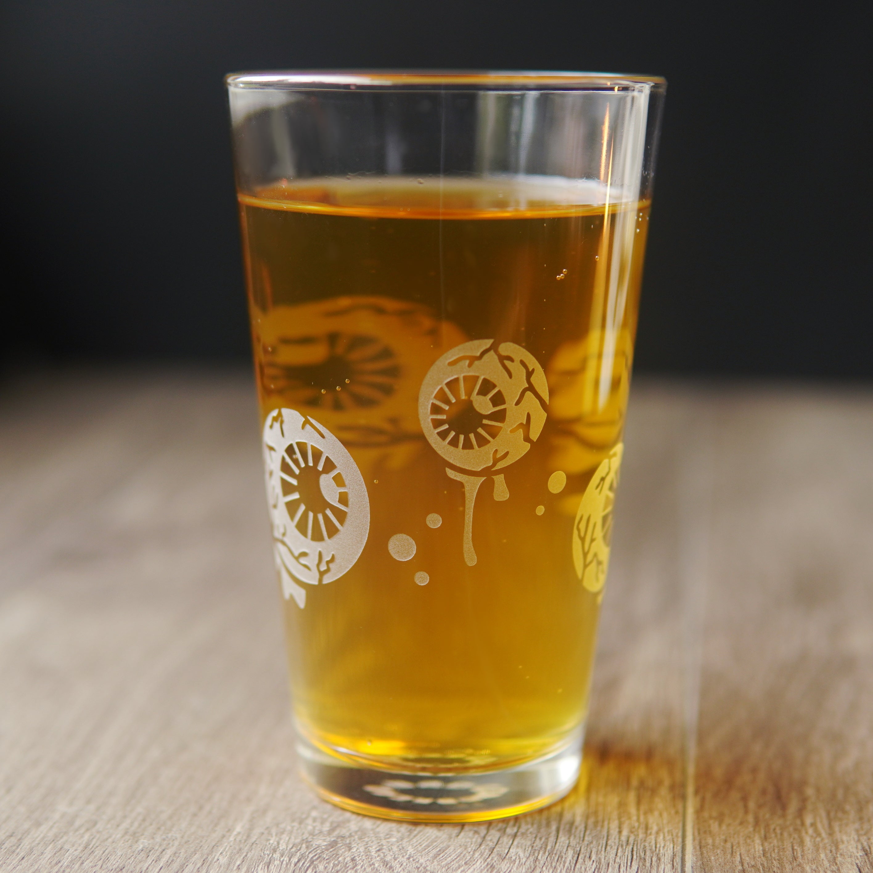 Pint glass engraved with dripping, veiny eyeballs and bubbles