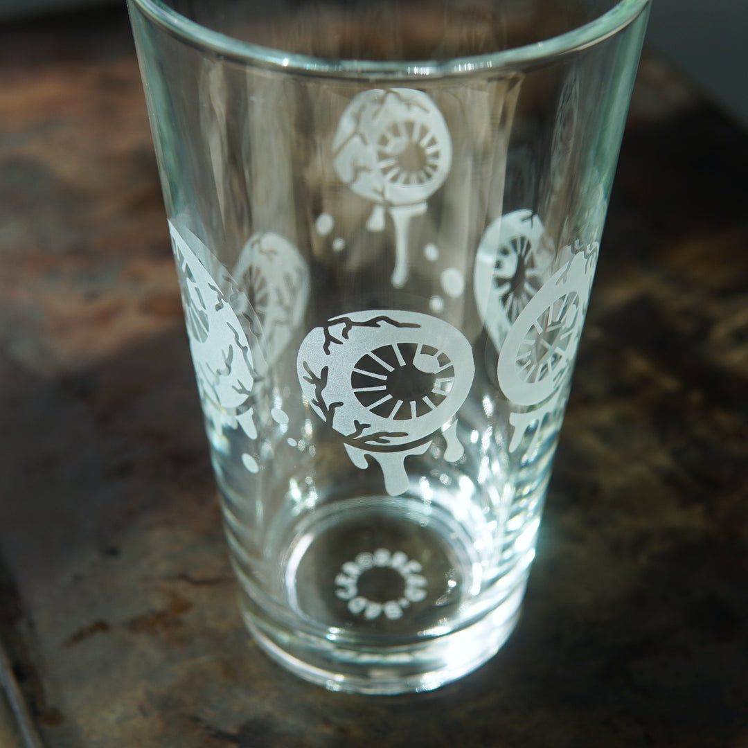 Pint glass engraved with dripping, veiny eyeballs and bubbles