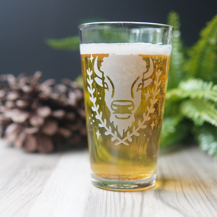 pint glass etched with a bison's face, full of yellow beer