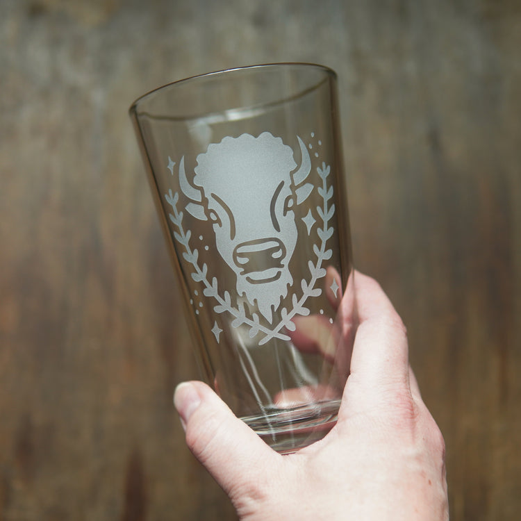Bison pint glass held in a hand