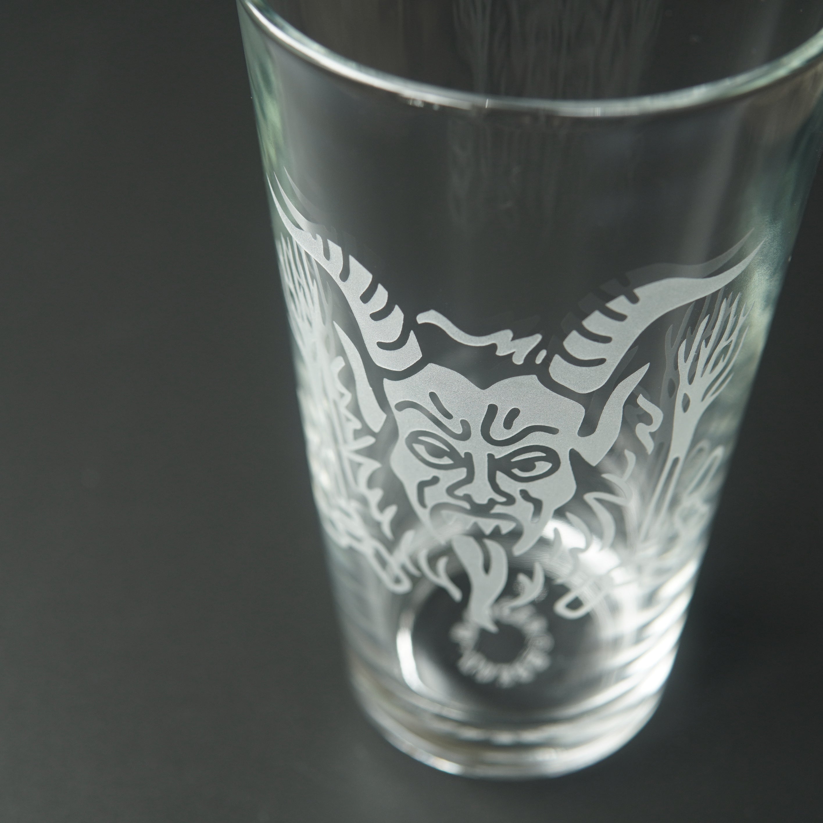 Pint glass engraved with Krampus' head