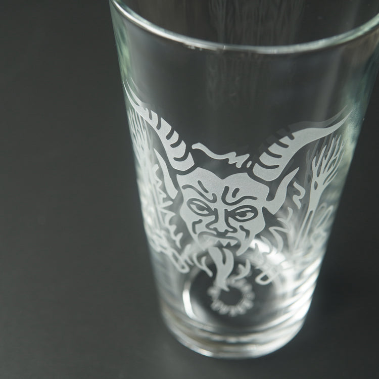 Pint glass engraved with Krampus' head
