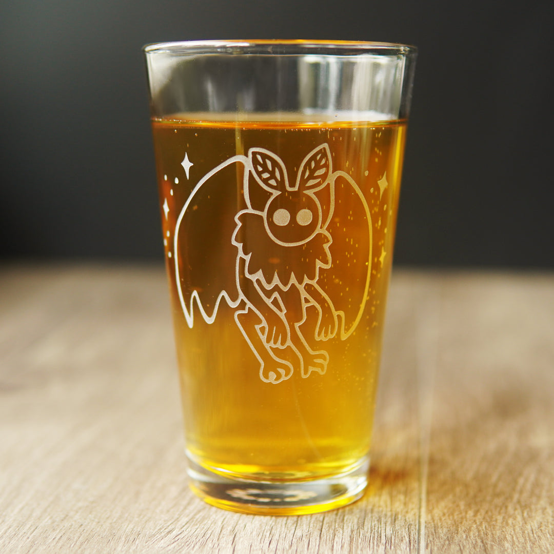 Mothman pint glass full of beer