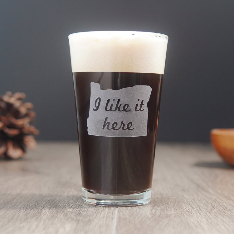 pint glass etched with the state of Oregon and the words "I like it here" inside the state
