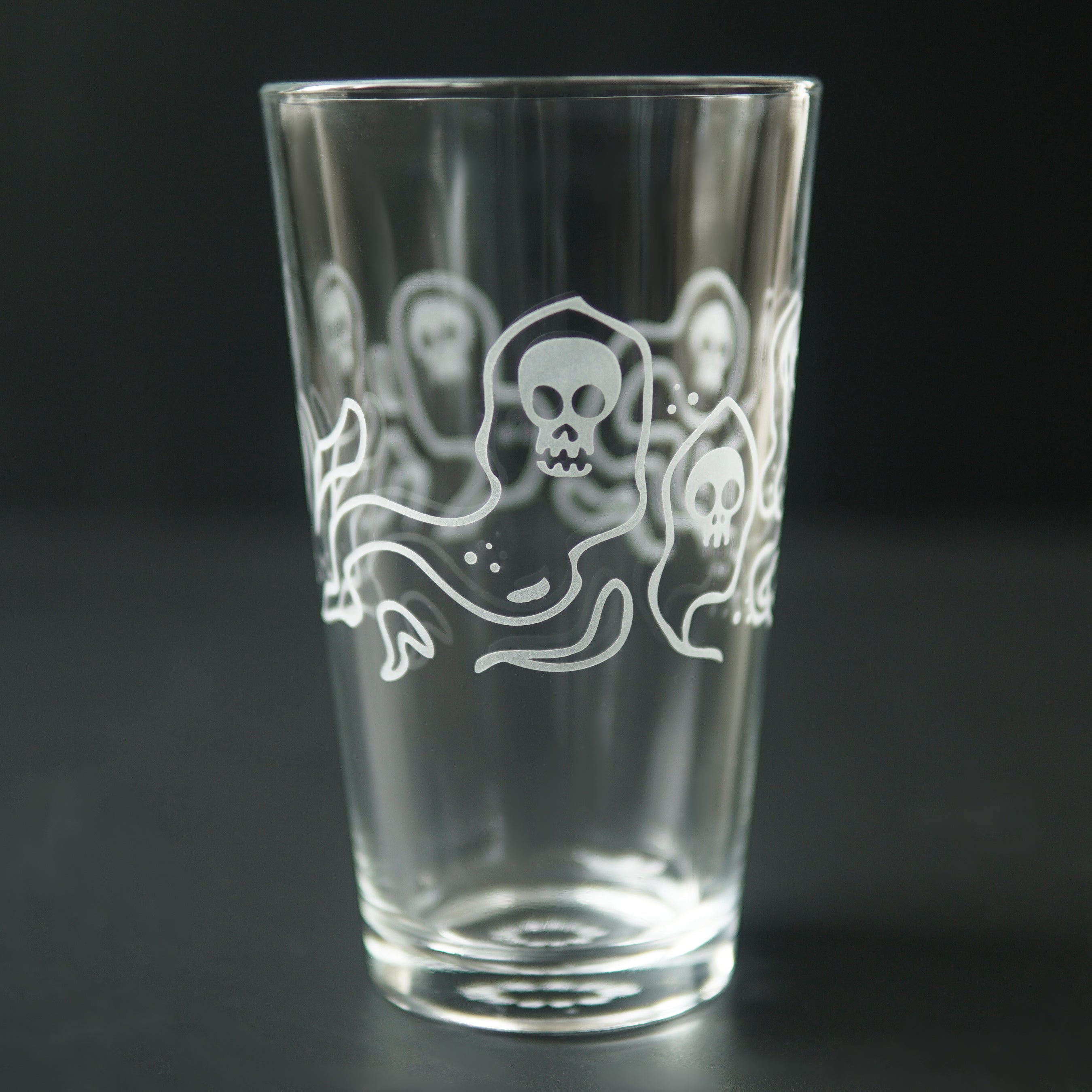 pint glass etched with ghosts with skull faces