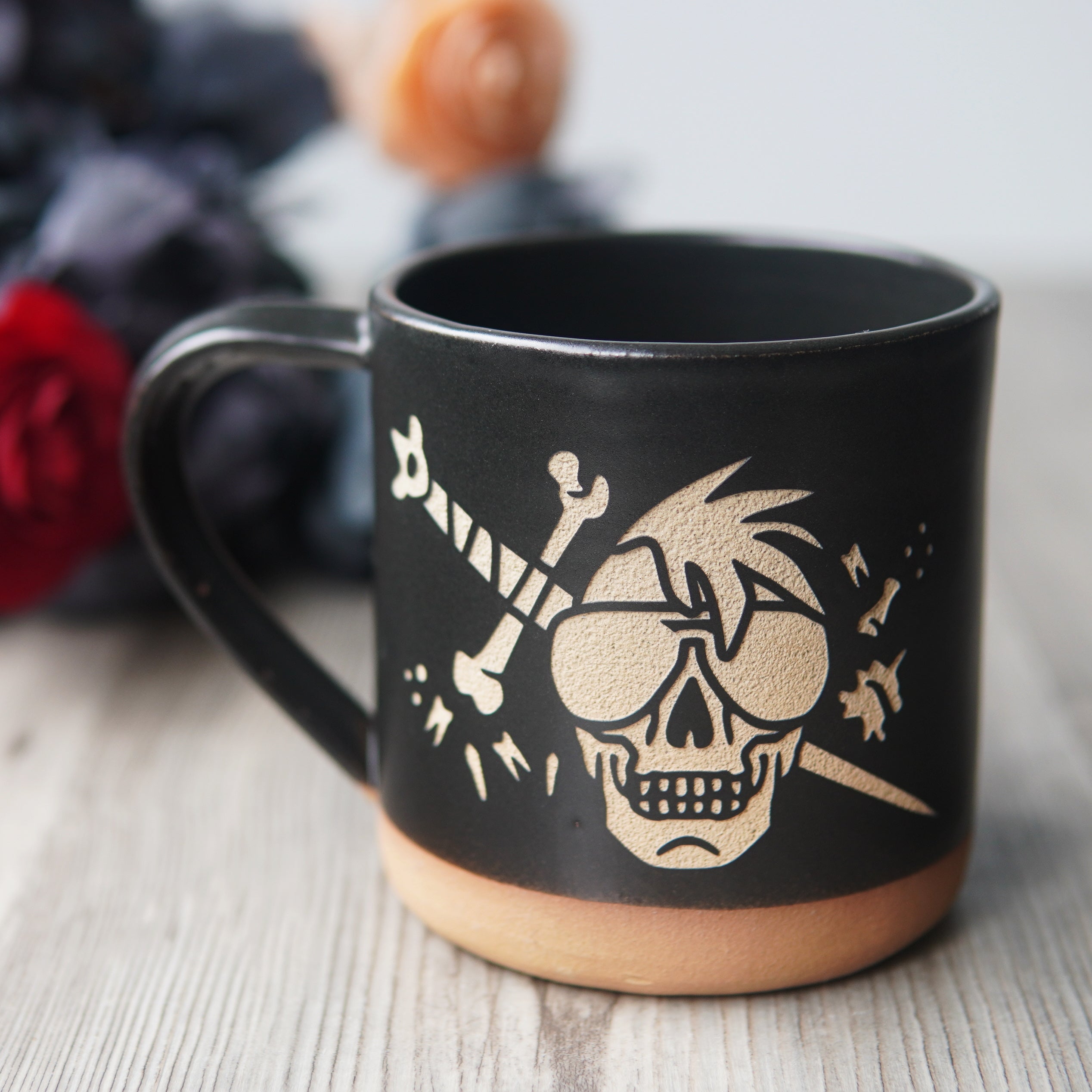 skull wearing aviator sunglasses with a bone sword and floating teeth, engraved onto a mug