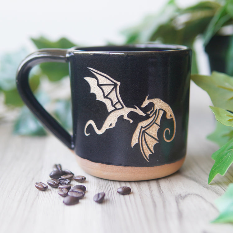 dragons engraved on a black mug