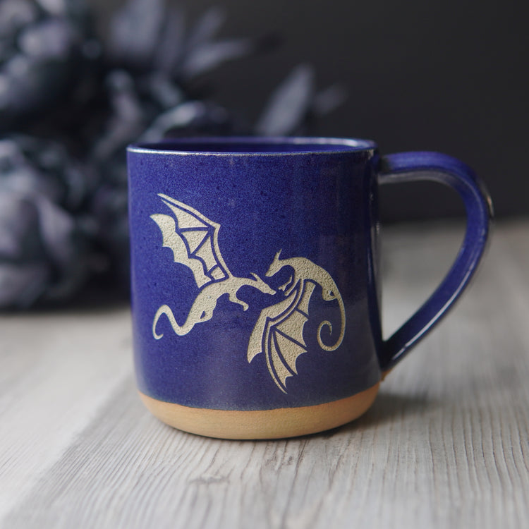 dragons engraved on a cobalt blue mug