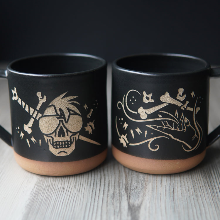 skull with bone sword mug next to hand summoning bones mug