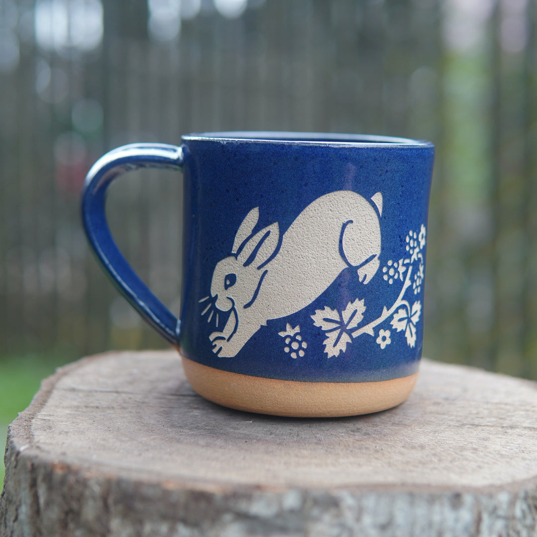 cobalt blue rabbit mug on a stump