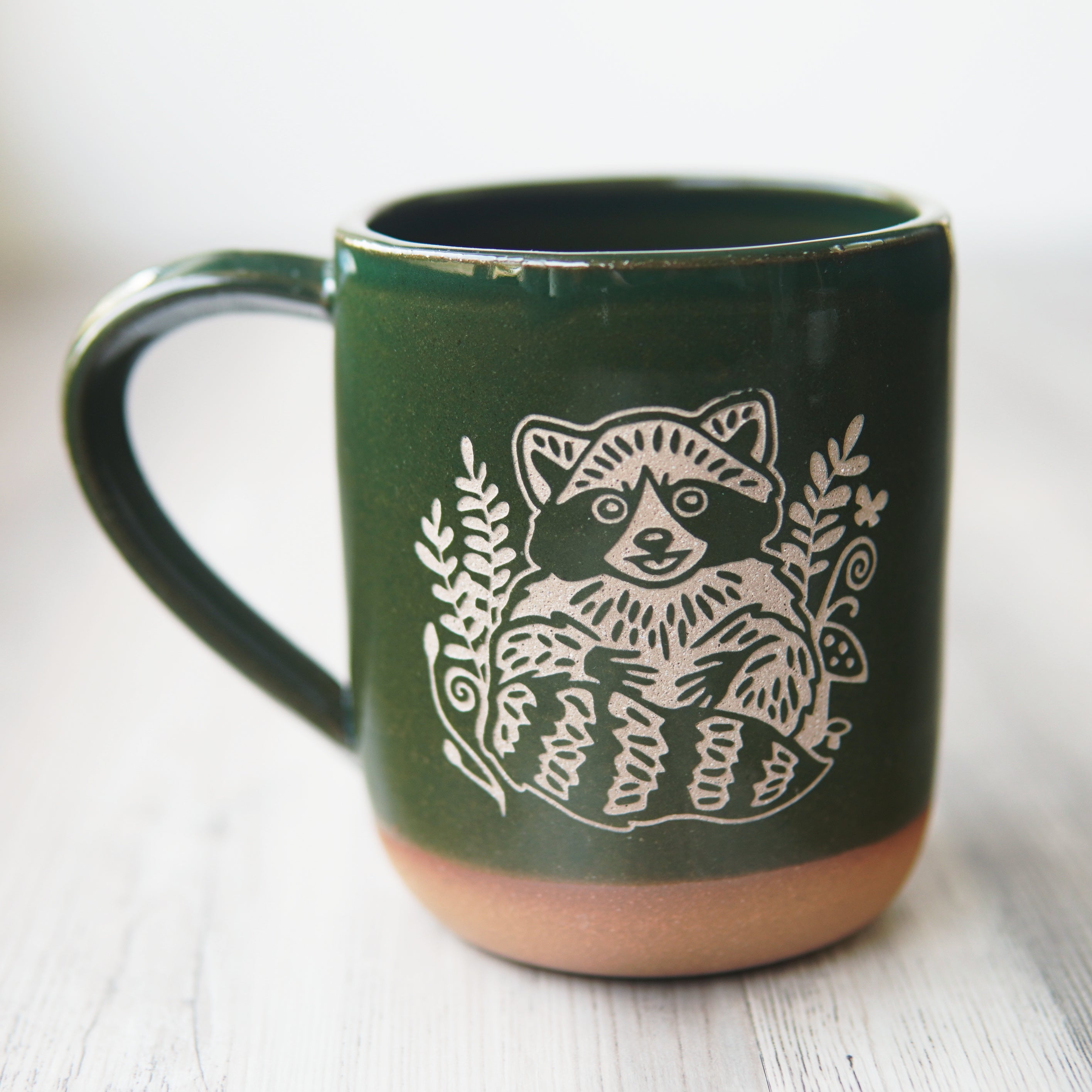 pine green raccoon mug
