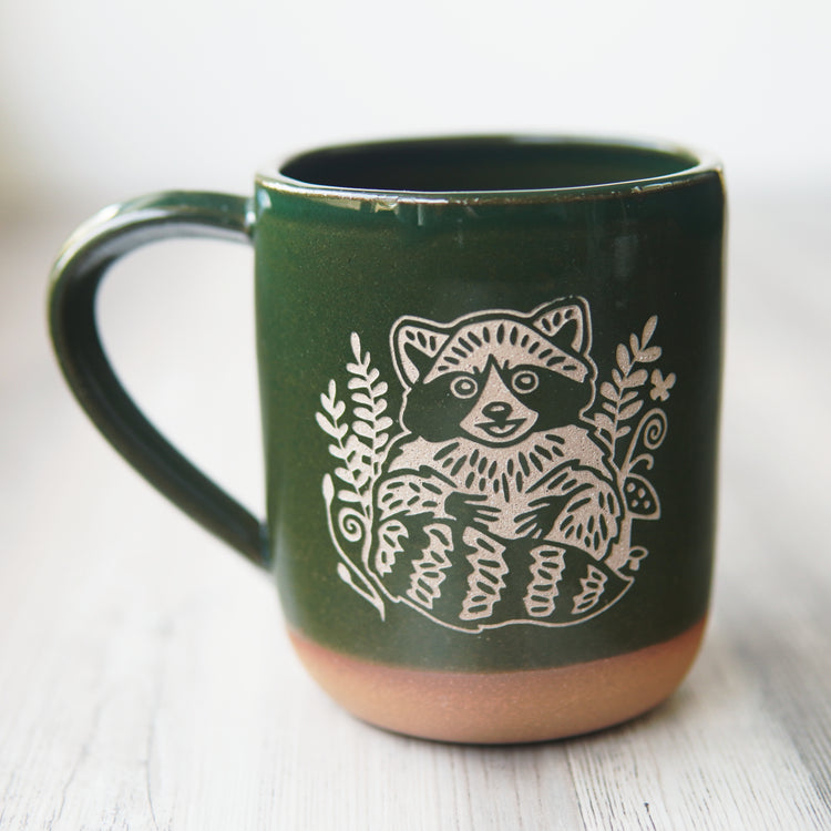 pine green raccoon mug