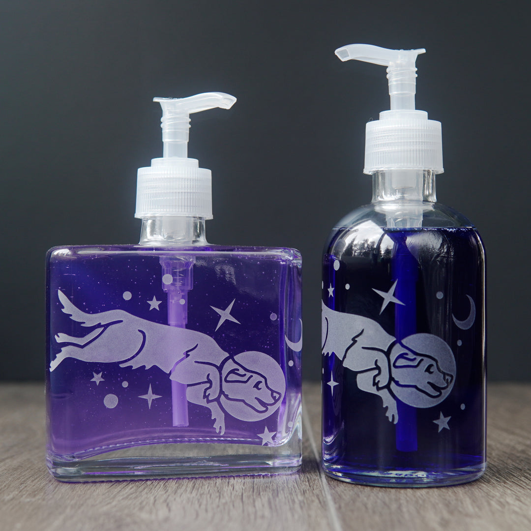 space dog soap dispensers filled with colorful dish soap
