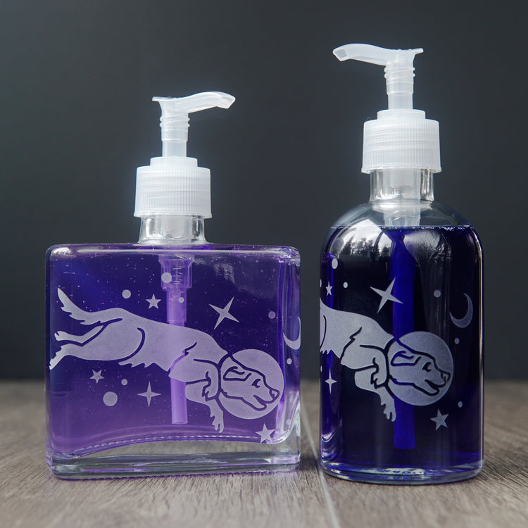 space dog soap dispensers filled with colorful dish soap