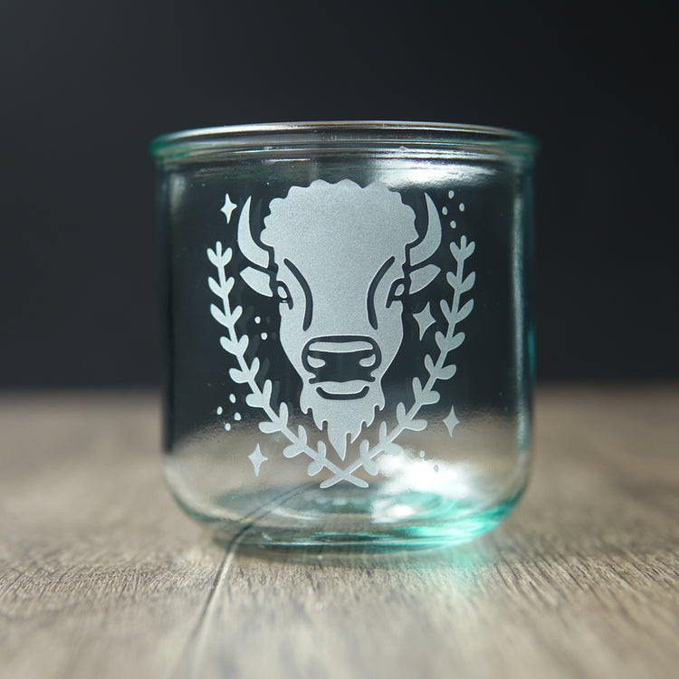 Bison engraved on a short blue-tinged recycled glass cup