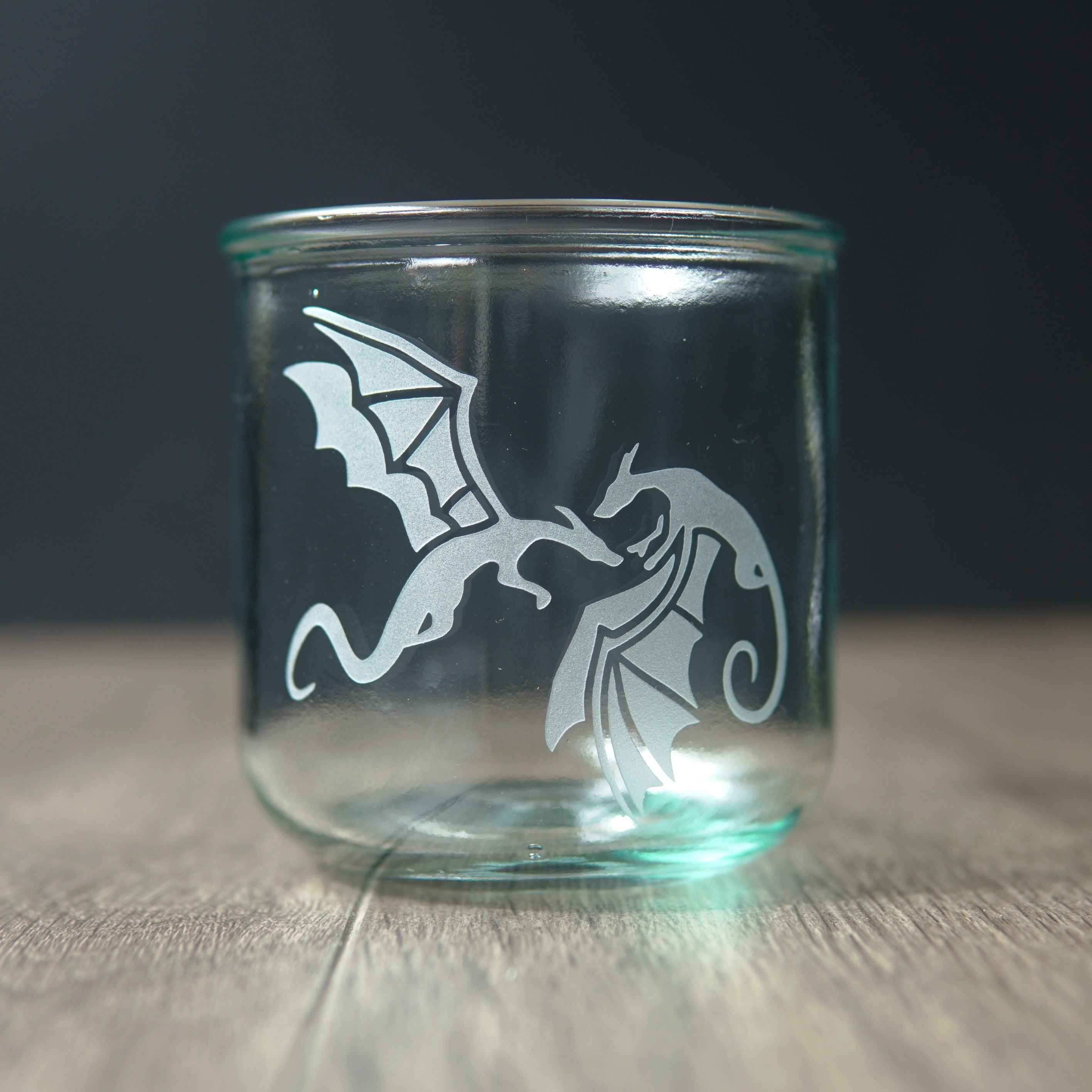 winged dragons engraved on a short straight-sided glass