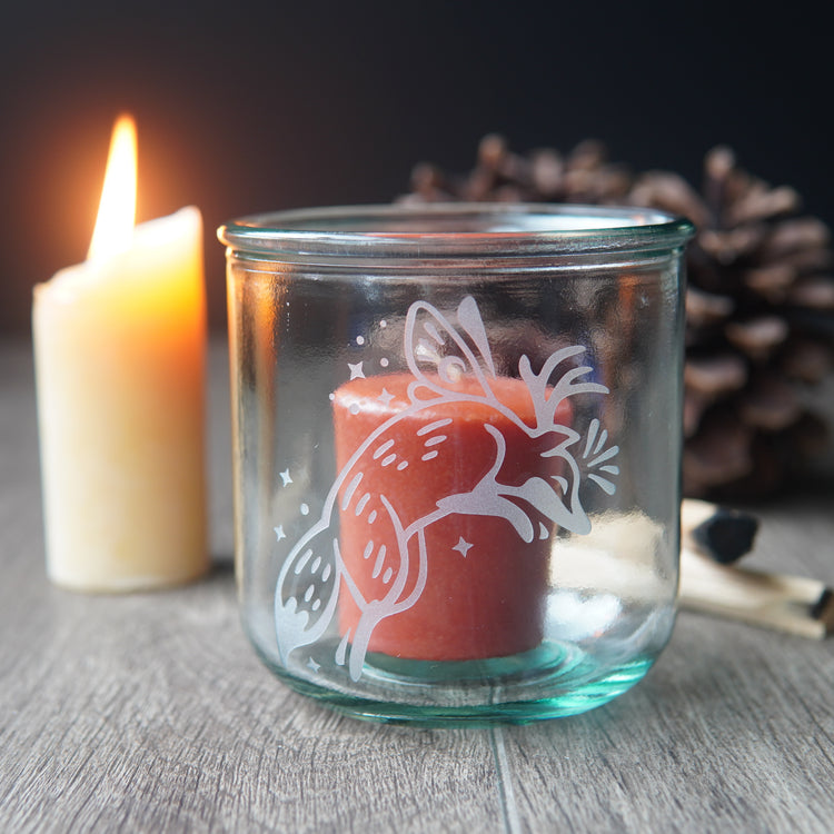 Fox fairy with wings and antlers etched onto a short glass with a votive candle
