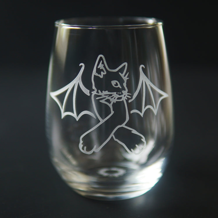 stemless wine glass engraved with a cat with crossed arms and bat wings