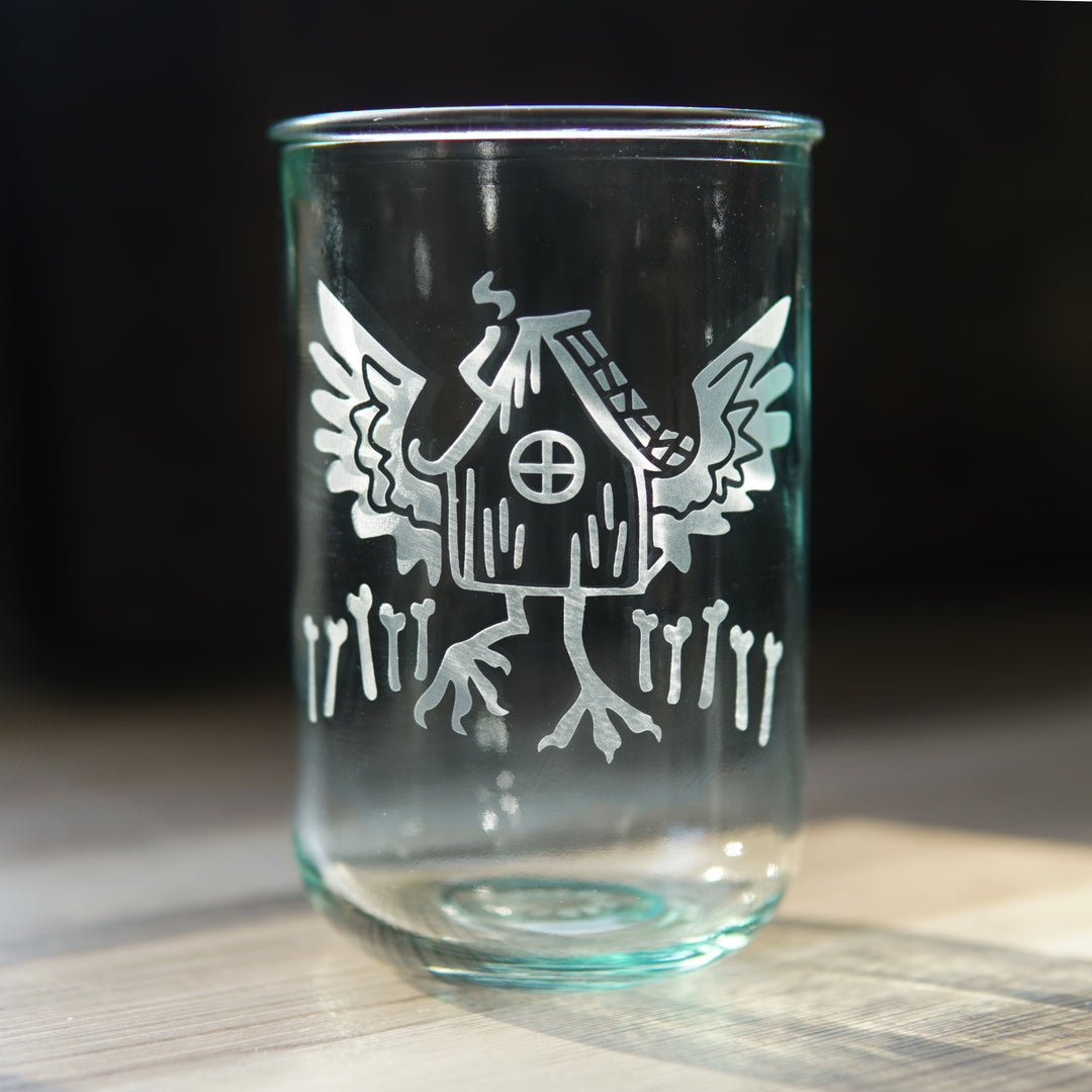 Baba Yaga's Hut etched onto a tall recycled glass cup