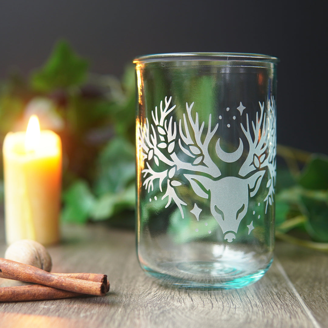 recycled glass cup engraved with a deer head with tree branches for antlers and a crescent moon and stars
