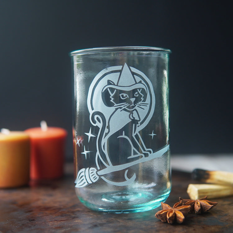 witch cat riding a broom etched onto a tall glass