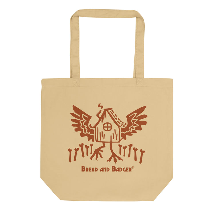 Beige tote bag with a Baba Yaga's hut graphic  and 'Bread and Badger' logo on a white background