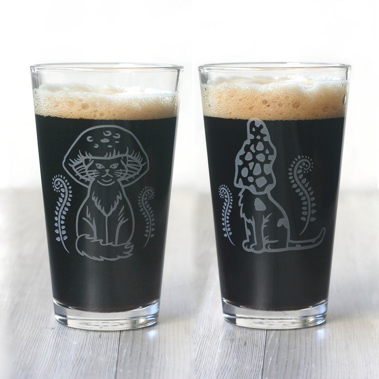 pair of pint glasses full of dark beer, engraved with two different cat designs wearing mushroom caps on their heads