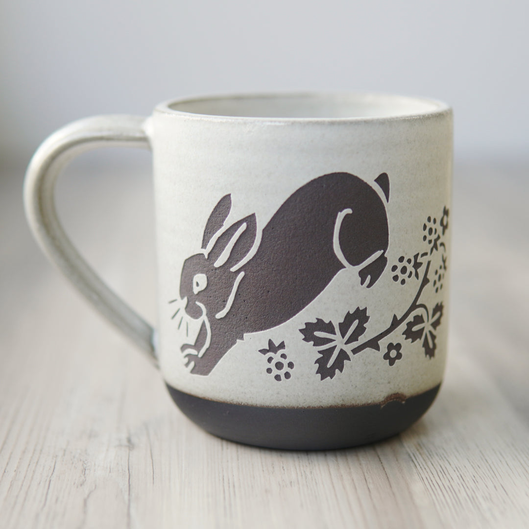 white glazed rabbit mug in dark brown clay