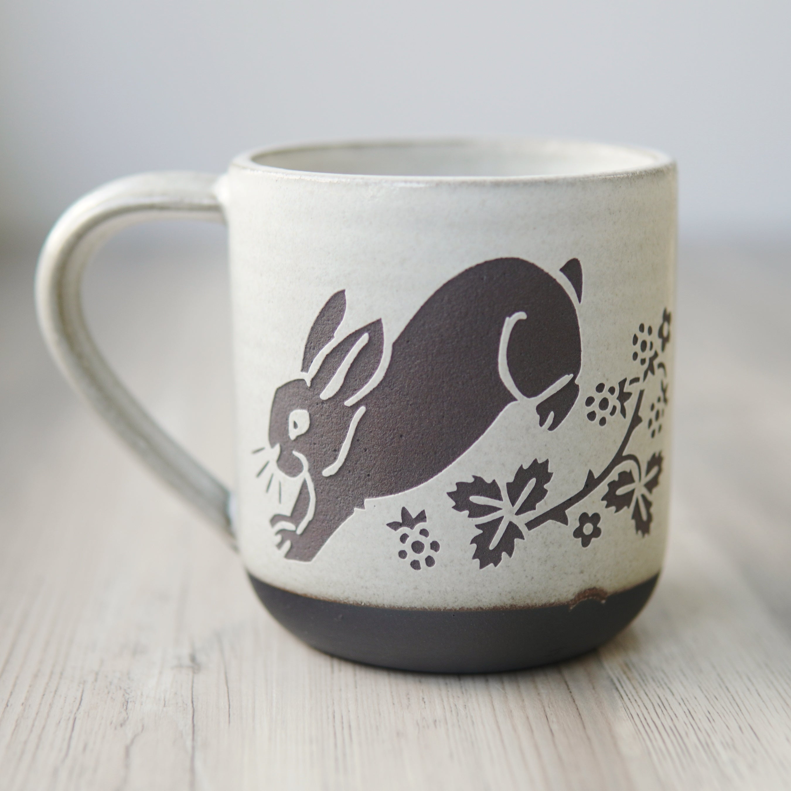 white glazed rabbit mug in dark brown clay