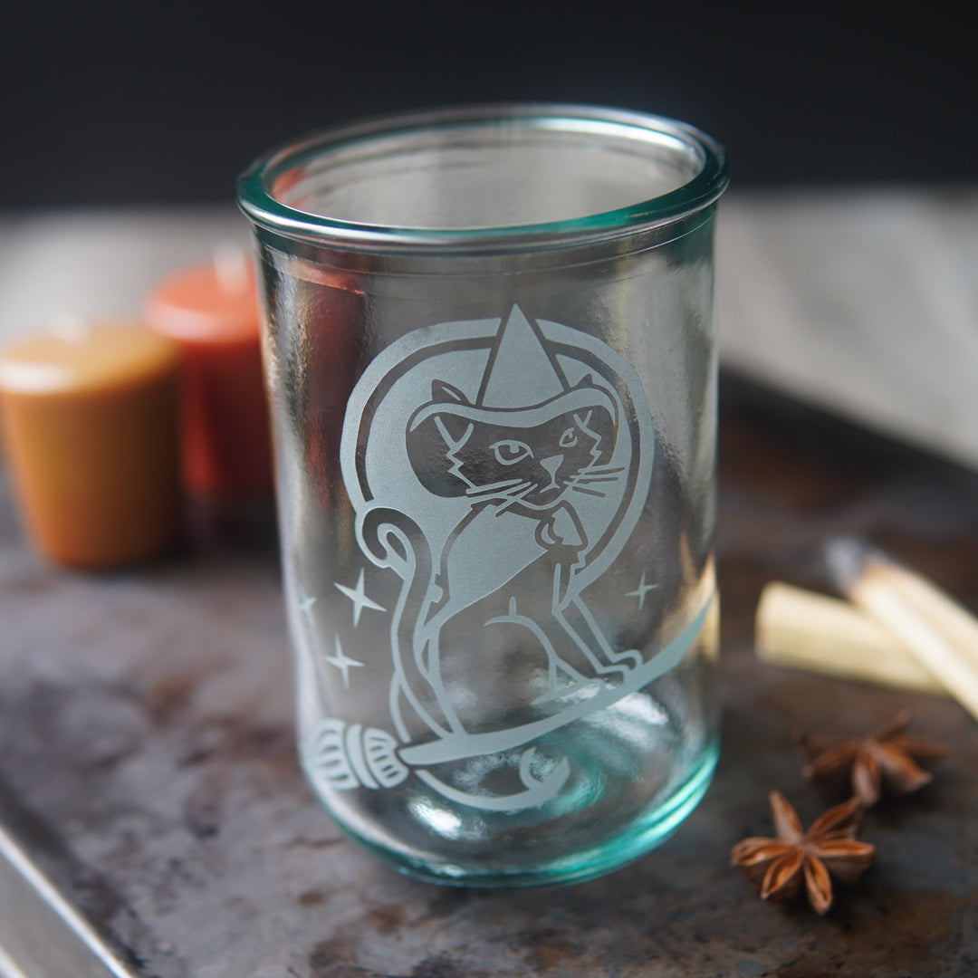 witch cat riding a broom etched onto a tall glass