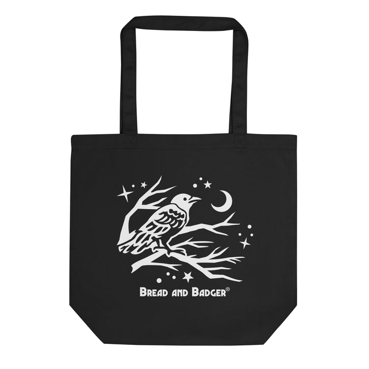 Black tote bag with a white bird design and 'Bread and Badger' logo on a white background