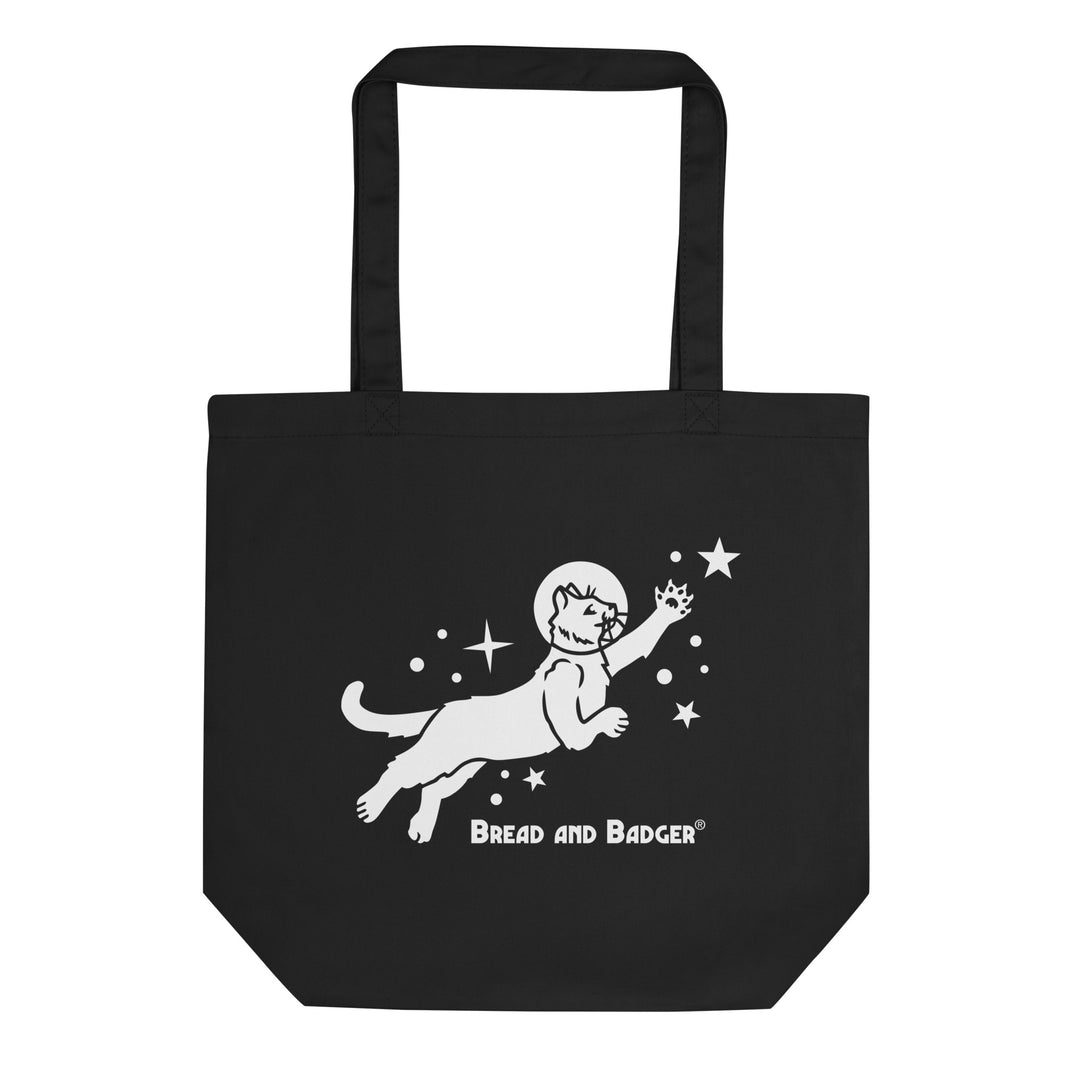 Black tote bag with white astronaut cat graphic and 'Bread and Badger' text on a white background