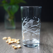 highball glass etched with a crow on branches and crescent moon