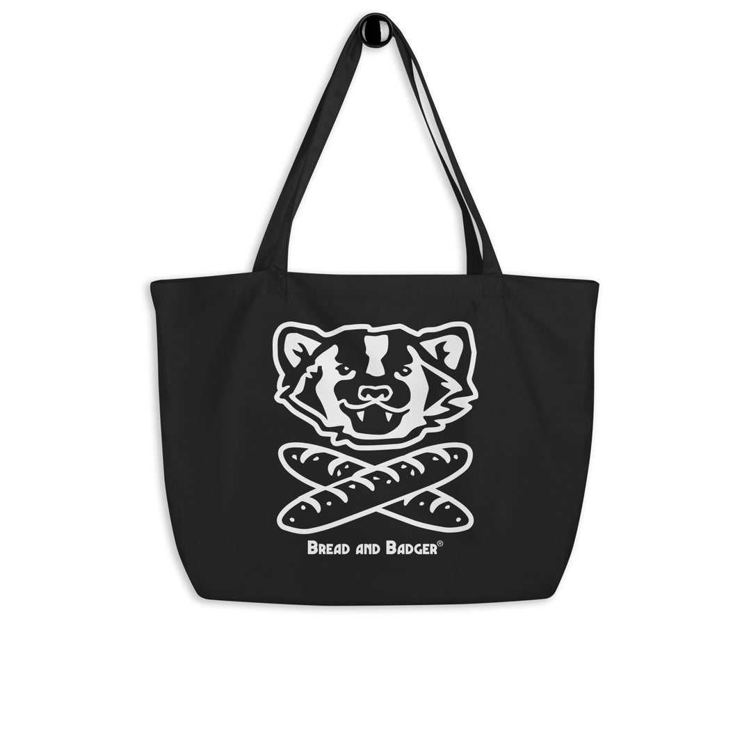 Black tote bag with a white logo and 'Bread and Badger' text on a white background. The logo is a badger's face with mouth open above two crossed baguettes.
