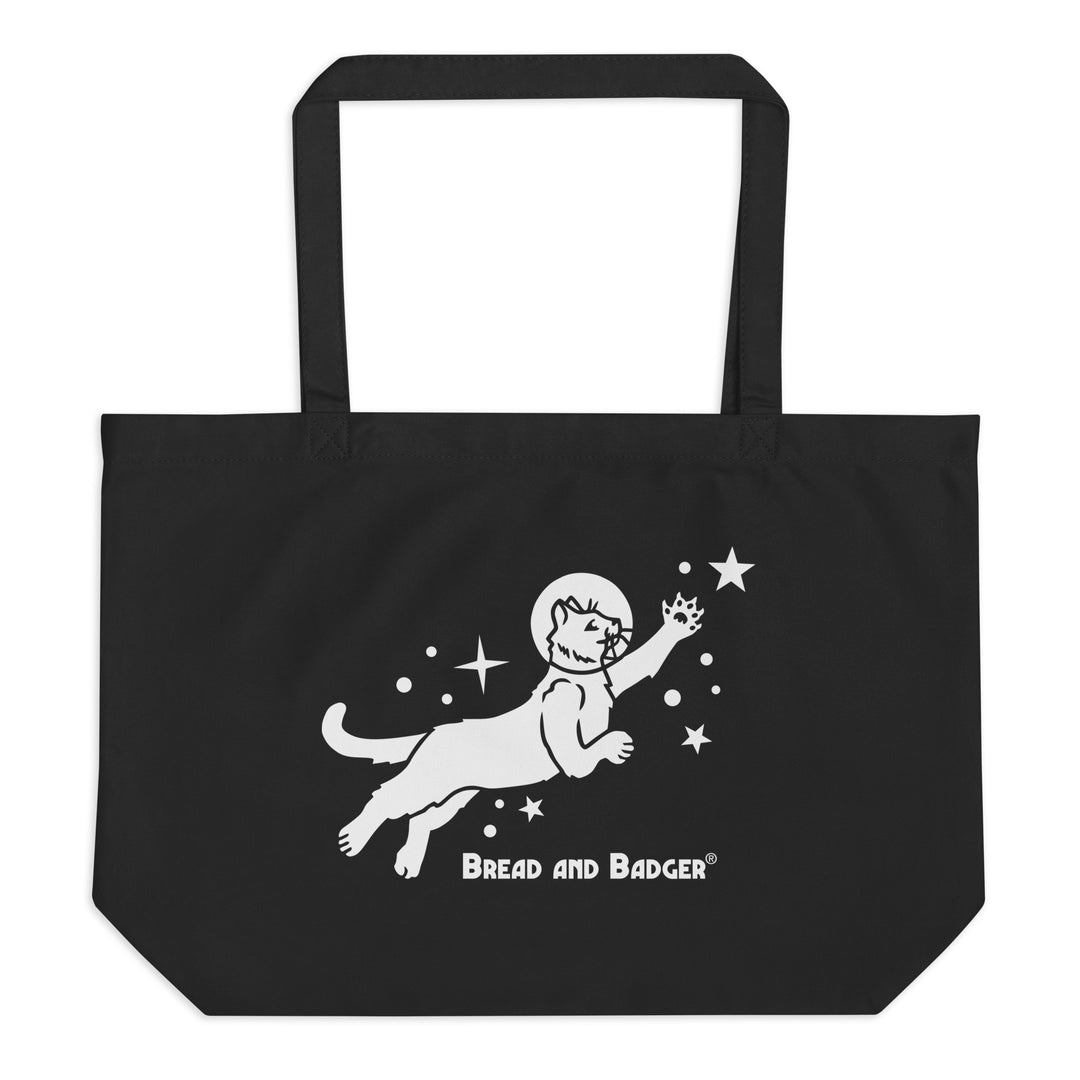 Black tote bag with white astronaut cat graphic and 'Bread and Badger' text on a white background